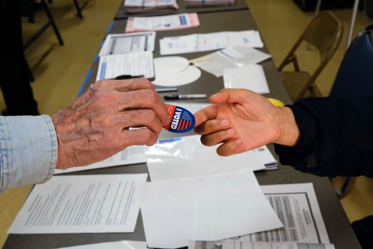 Early voter receives his I-Voted sticker, at an early voting polling station at the Ranchito Avenue Elementary School in the Panorama City section of Los Angeles on Monday, March 2, 2020.