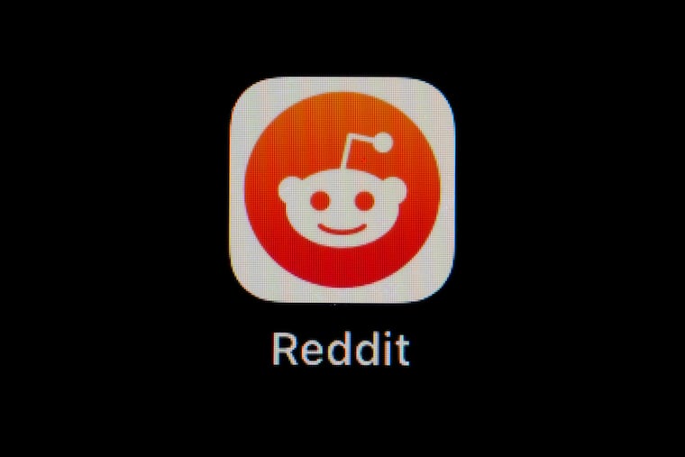 The Reddit app icon is seen on a smartphone. Reddit's lawsuit alleges that the start-up Perplexity benefited from improperly using its website as AI fuel.