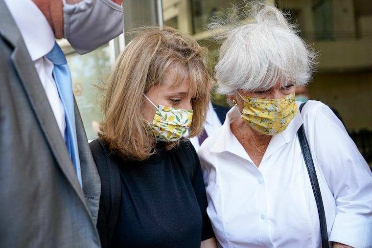 Allison Mack, center, leaves federal court with her mother Mindy Mack after being sentenced.