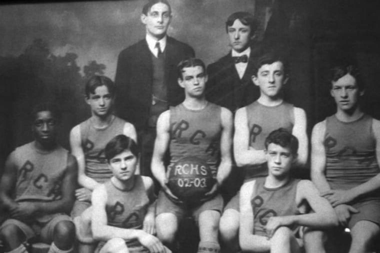 Roman Catholic's 1902-03 team included John Lee (left), John Corkery (holding ball), and Maurice Corkery (on floor at right). Coach William Markward is at left in the back row.
