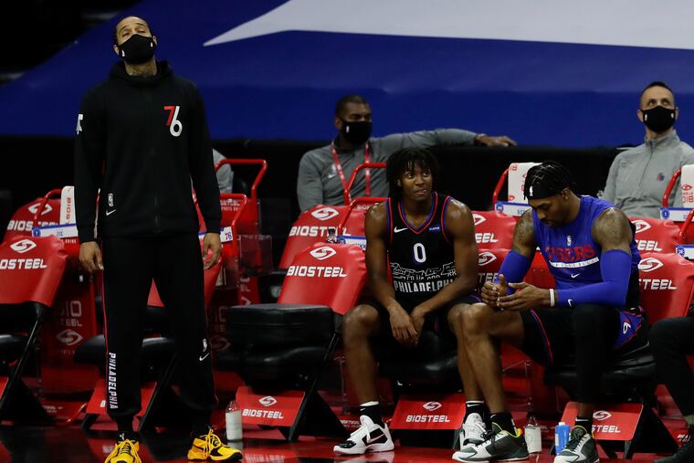 Mike Scott, Tyrese Maxey and Dwight Howard on the bench against the Denver Nuggets.