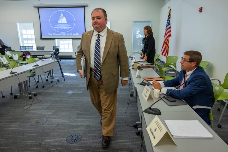 Rep. John Lawrence, chairman of the House Select Committee on Restoring Law and Order, leaving the symposium room after first half of testimony Thursday.