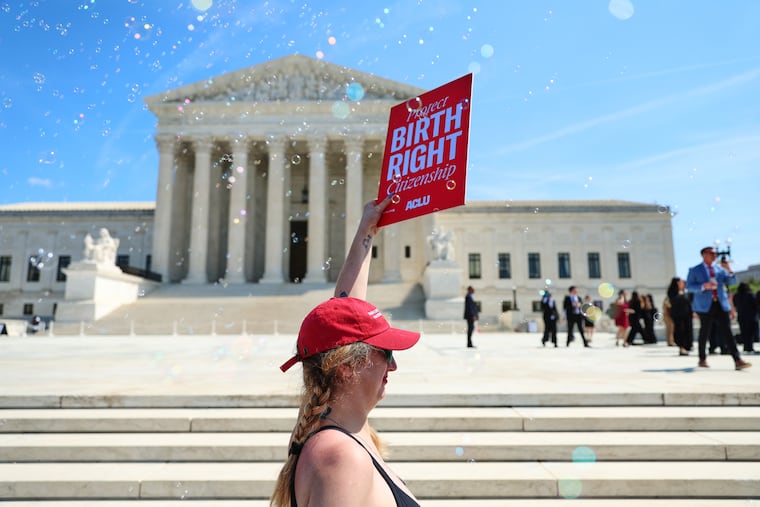 Demonstrators rally outside the U.S. Supreme Court on April 1 after justices heard oral arguments on whether President Donald Trump can deny citizenship to children born to parents who are in the United States illegally or temporarily.