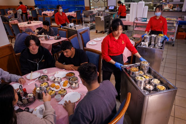 Jing Li with Dim Sum cart distributing food to customers in the dining room. China Gourmet, 2842 St. Vincent Street, Philadelphia on Friday, October 27, 2023.