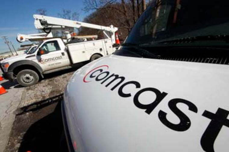 Comcast logos are displayed on installation trucks in Pittsburgh. Comcast Corp., the country's largest cable company, reported a 30 percent profit increase in the first quarter, beating expectations on the strength of Super Bowl advertising and its popular broadband service. GENE J. PUSKAR / Associated Press, file