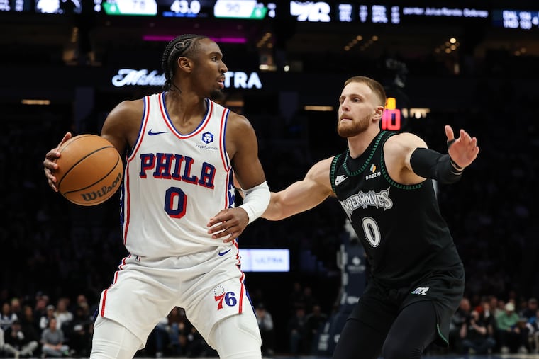 Philadelphia 76ers guard Tyrese Maxey (0) handles the ball against Minnesota Timberwolves guard Donte DiVincenzo (0) during the second half of an NBA basketball game Sunday, Feb. 22, 2026, in Minneapolis. (AP Photo/Stacy Bengs)