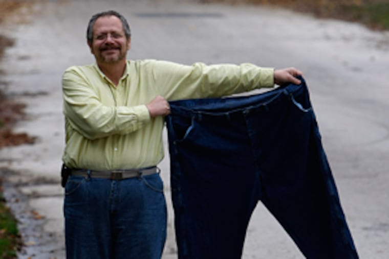 Michael Pezzano holds the 53-inch waist pants he wore before his bariatric surgery about a year ago. ( Michael S. Wirtz / Staff Photographer )