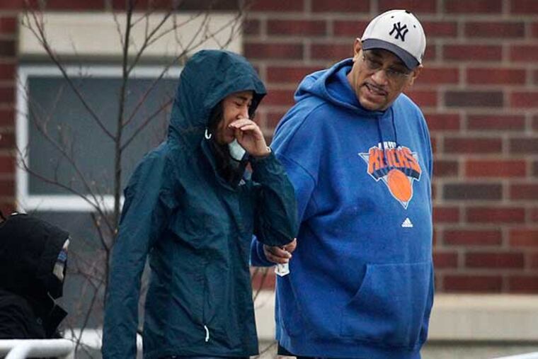 A shaken student leaves Upper Dublin High School Monday after a scare over an umbrella that was mistaken for a rifle on video surveillance cameras. (Alejandro A. Alvarez / Staff Photographer)