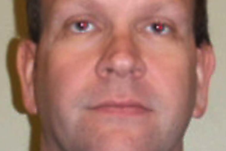 John Martin hid cameras at Glou. Catholic, police said.