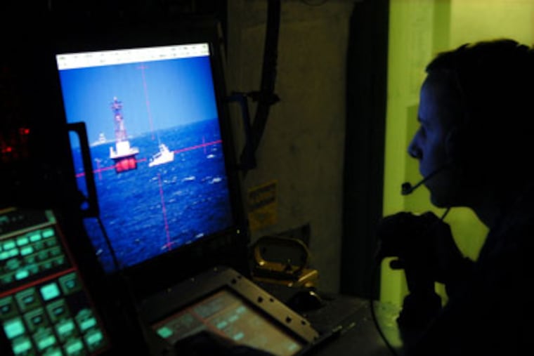 Inside the Aegis combat information center of the USS Wayne E. Meyer (DDG-108), Seaman Tyler Hill, 21, of Laurens, S.C. monitors pleasure craft and bouys on the Delaware River. ( Tom Gralish / Staff Photographer )