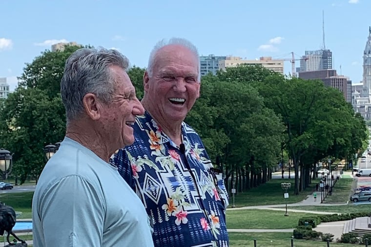 Larry Bowa and Charlie Manuel with a Center City skyline in the background.