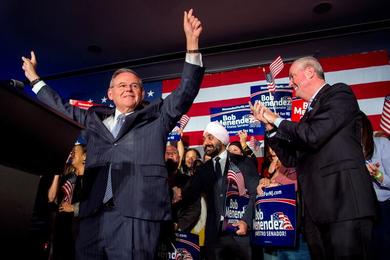 U.S. Sen. Bob Menendez celebrates his re-election in Hoboken November 6, 2018. N.J. Gov. Phil Murphy is at right.