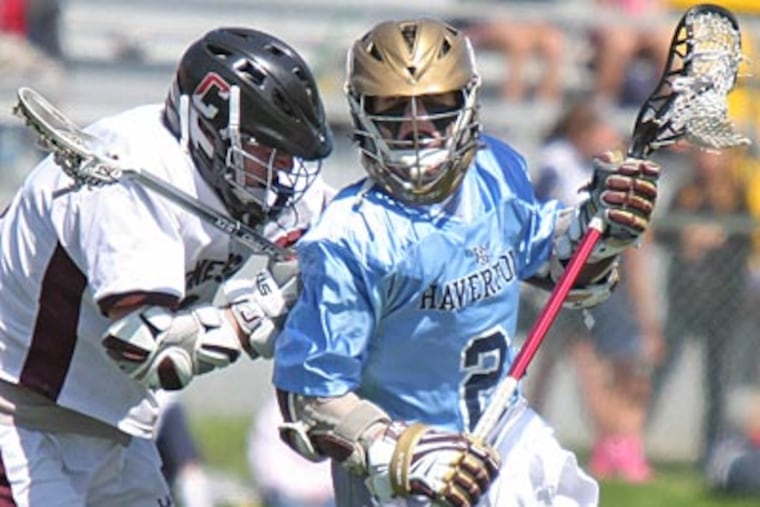 Haverford School's Sam Rohr circles the net while checked from behind
by Conestoga's Zachary Gregory. (Lou Rabito / Staff)