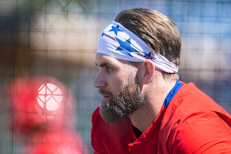 Phillies star Bryce Harper looks on during a spring-training workout Thursday in Clearwater, Fla.