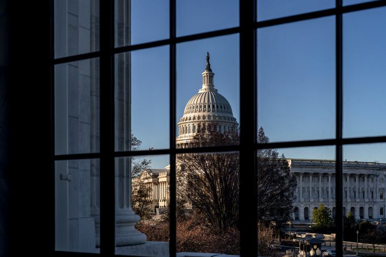 The U.S. Capitol is seen through a window in the Russell Senate Office Building in March.