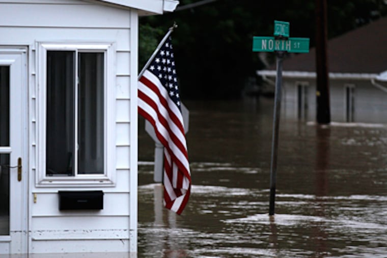 In West Pittston, Pa., near Wilkes-Barre, floodwaters left homes partially submerged. The levees that spared Wilkes-Barre from the worst apparently aggravated problems in neighboring towns. (Matt Rourke / Associated Press)