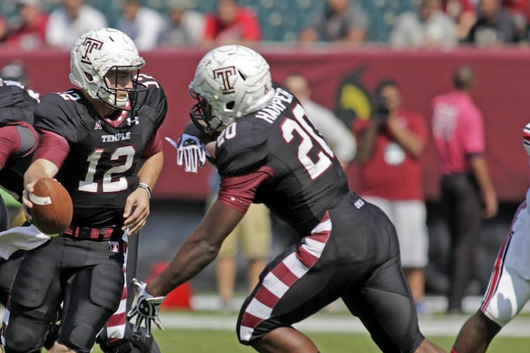 Former Temple quarterback Connor Reilly, here handing the ball off to former Temple running back Kenny Harper in 2013, remembers his first college start.
