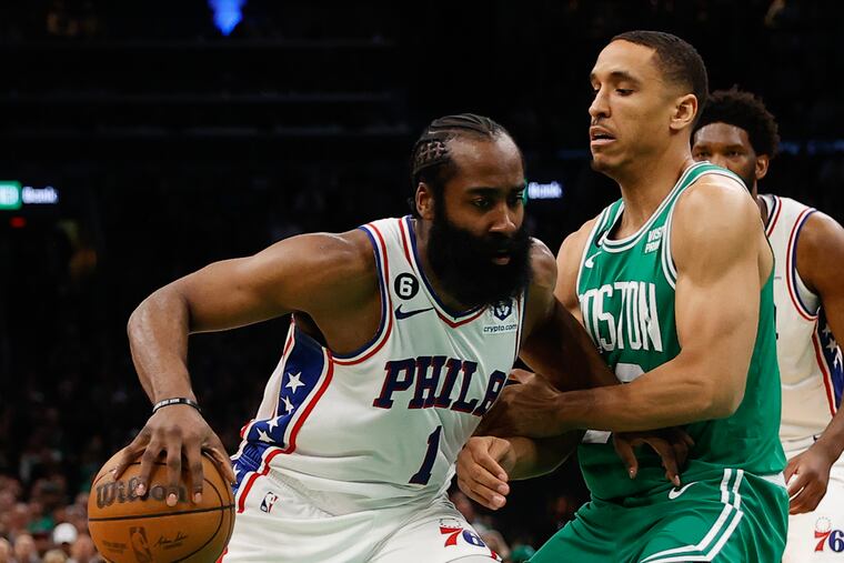 Sixers guard James Harden dribbles the basketball against Boston Celtics guard Malcolm Brogdon.