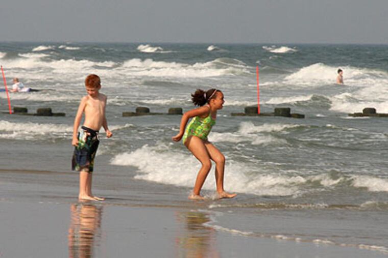 Children bravely play in the ocean at 23rd street and the beach in North Wildwood Thursday with water temperatures averaging just 62 degrees. (Jen Arthur / For the Inquirer)