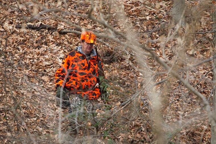 Bob DIckle, of Conestoga PA emerges empty handed from the woods in the state game lands that border the Octoraro Creek in Lancaster County on Tuesday, December 02, 2013. ( ED HILLE / Staff Photographer )