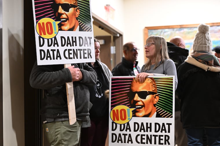 People opposed to a data center proposal at the former Pennhurst State School and Hospital grounds talk during a break in an East Vincent Township supervisors meeting in December.