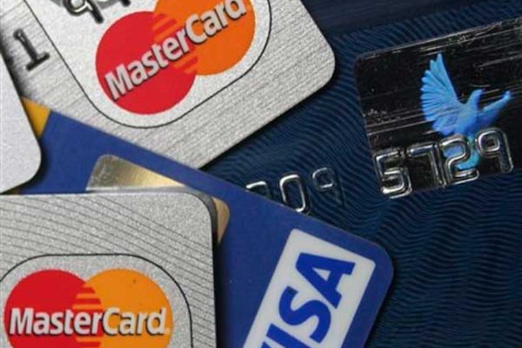 FILE - This file photo taken Nov. 18, 2009, a pile of MasterCard and VISA credit cards are displayed in Frankfurt, Germany. A sweater you buy for Christmas goes on sale for half price the next day. You might be able to get the difference back if you paid with a credit card.(AP Photo/Jochen Krause, File)