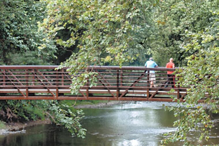 A bridge across the Manatawny Creek - a tributary of the Schuylkill River near Pottstown - is along a recently completed 19-mile portion of the trail. (Clem Murray/Inquirer)