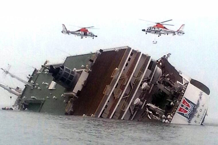 Rescue helicopters fly over a sinking South Korean passenger ferry that was carrying more than 450 passengers, mostly high school students, Wednesday, April 16, 2014, off South Korea's southern coast. Hundreds of people are missing despite a frantic, hours-long rescue by dozens of ships and helicopters. At least four people were confirmed dead and 55 injured. (AP Photo/Yonhap) KOREA OUT