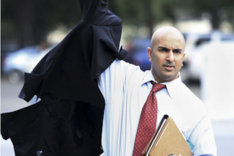 Treasury Department Assistant Secretary Neel Kashkari puts his jacket on as he arrives at the Senate Office Building. (AP)