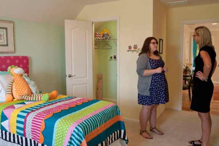 Student Elizabeth Pass (left) talks with teacher Lauren Newman in a room she designed.