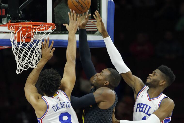 Jahlil Okafor (left) and Nerlens Noel (right) double-team an opponent.
