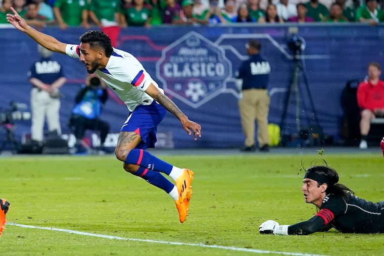 The United States' Jesus Ferreira celebrates his goal as Mexico goalkeeper Carlos Acevedo looks on during the second half of the inaugural Continental Clasico exhibition soccer match on Wednesday in Glendale, Ariz.