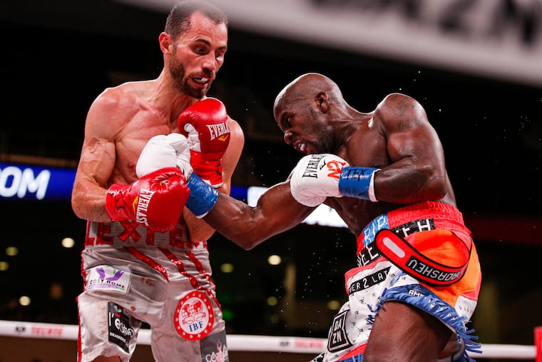 Tevin Farmer, right, lands a punch on Guillaume Frenois in the fifth round of a boxing match, Saturday, July 27, 2019, in Arlington, Texas. Farmer won the 12-round match.