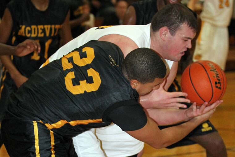 Wood's Joe LoStracco (right) battles for the basketball against Bishop McDevitt High's Allen Harmon.