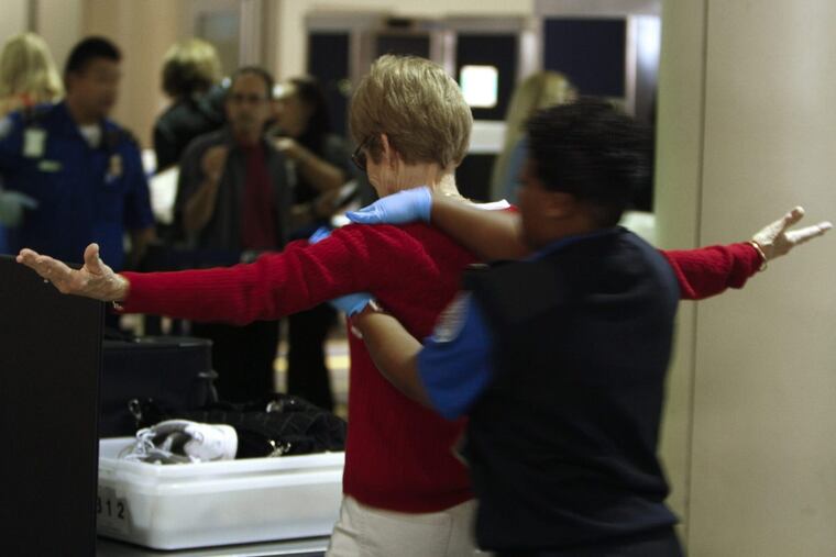 A TSA agent pats down a traveler at Los Angeles International Airport in 2011. Under a plan being considered by the Transportation Security Administration, security checkpoints would be eliminated at more than 150 smaller U.S. airports.