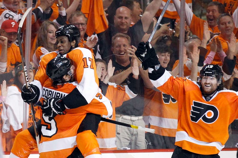 Wayne Simmonds leaps into the arms of Braydon Coburn after scoring second-period power-play goal.