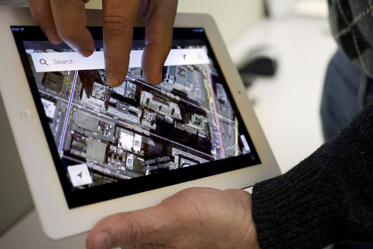 The new Google Maps application is demonstrated in New York on Thursday, Dec. 13, 2012. The world's most popular online mapping system returned late Wednesday with the release of the Google Maps iPhone app. The release comes nearly three months after Apple Inc. replaced Google Maps as the device's built-in navigation system and inserted its own map software into the latest version of its mobile operating system. (AP Photo/Karly Domb Sadof)