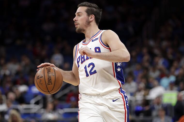 Sixers’ point guard T.J. McConnell (12) moves the ball against the Orlando Magic during the first half of an NBA basketball game, Thursday, March 22, 2018, in Orlando, Fla.