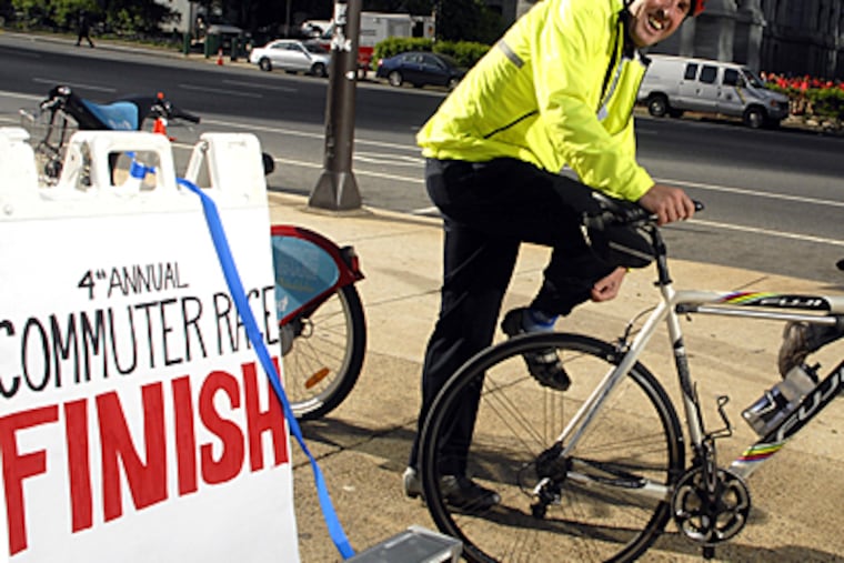Pat Cunnane, president of Fuji Bicycles, arrives after winning the "Commuter Race.". (Tom Gralish / Inquirer).