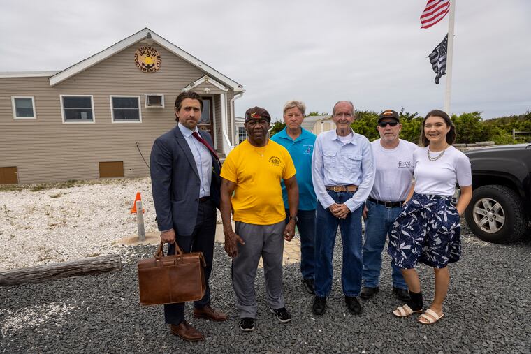 From left are club members, attorney/member Chris Gillin-Schwart, Burgess Hamer, Joe Givens, Joe Seitz, Eddie Claven, Emaleigh Kaithern outside the clubhouse. The state of New Jersey wants the Sunset Beach Sportsmen's Club, 502 Sunset Blvd, Cape May, NJ., a longtime social and fishing club at Cape May Point, to dissolve so that it can reclaim the land for nature. Photograph taken on Thursday, May 26, 2022.