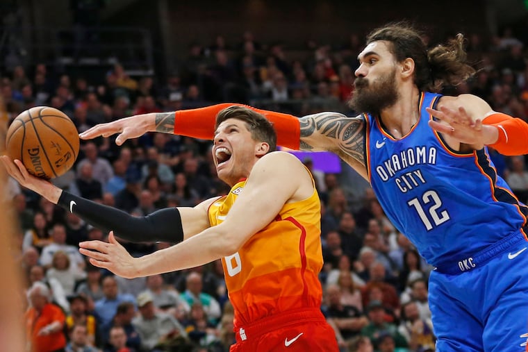 Kyle Korver tries to put up a shot as the Thunder's Steven Adams defends.