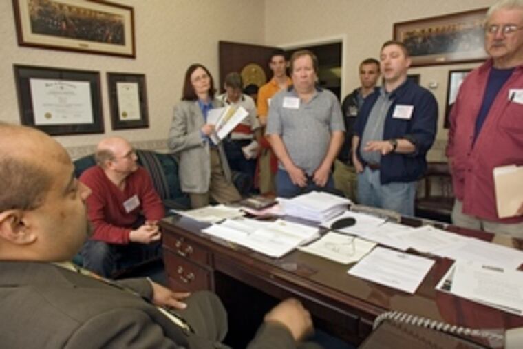 State Rep. Angel Cruz (D., Phila.) meets with a group of gun-rights supporters after a rally yesterday at the Capitol.