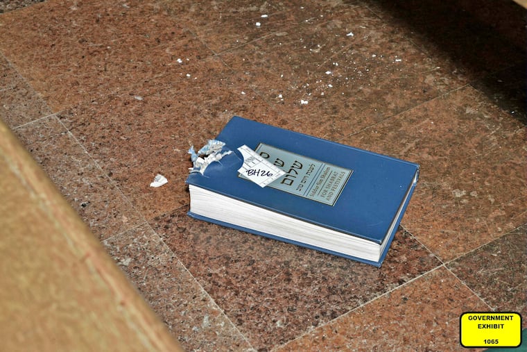 This photo of a bullet-damaged prayer book in the Tree of Life synagogue building in Pittsburgh was entered as a court exhibit by prosecutors in the trial of Robert Bowers.