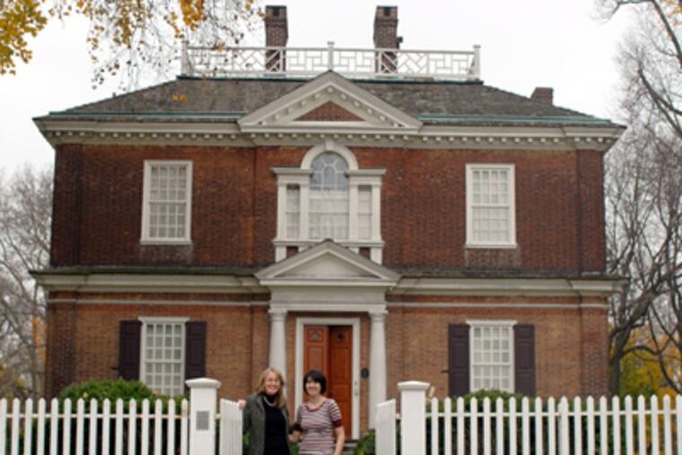 At Woodford in Fairmount Park are tour guide Christine Mifsud (left), who devised the art contest, and Moore College of Art and Design student Dana Osburn. (Ron Tarver / Staff Photographer)