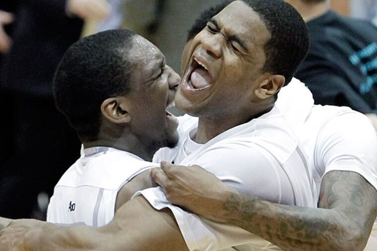 St. Joe's Langston Galloway (left) is hugged by teammate Ronald Roberts. (Elizabeth Robertson/Staff Photographer)