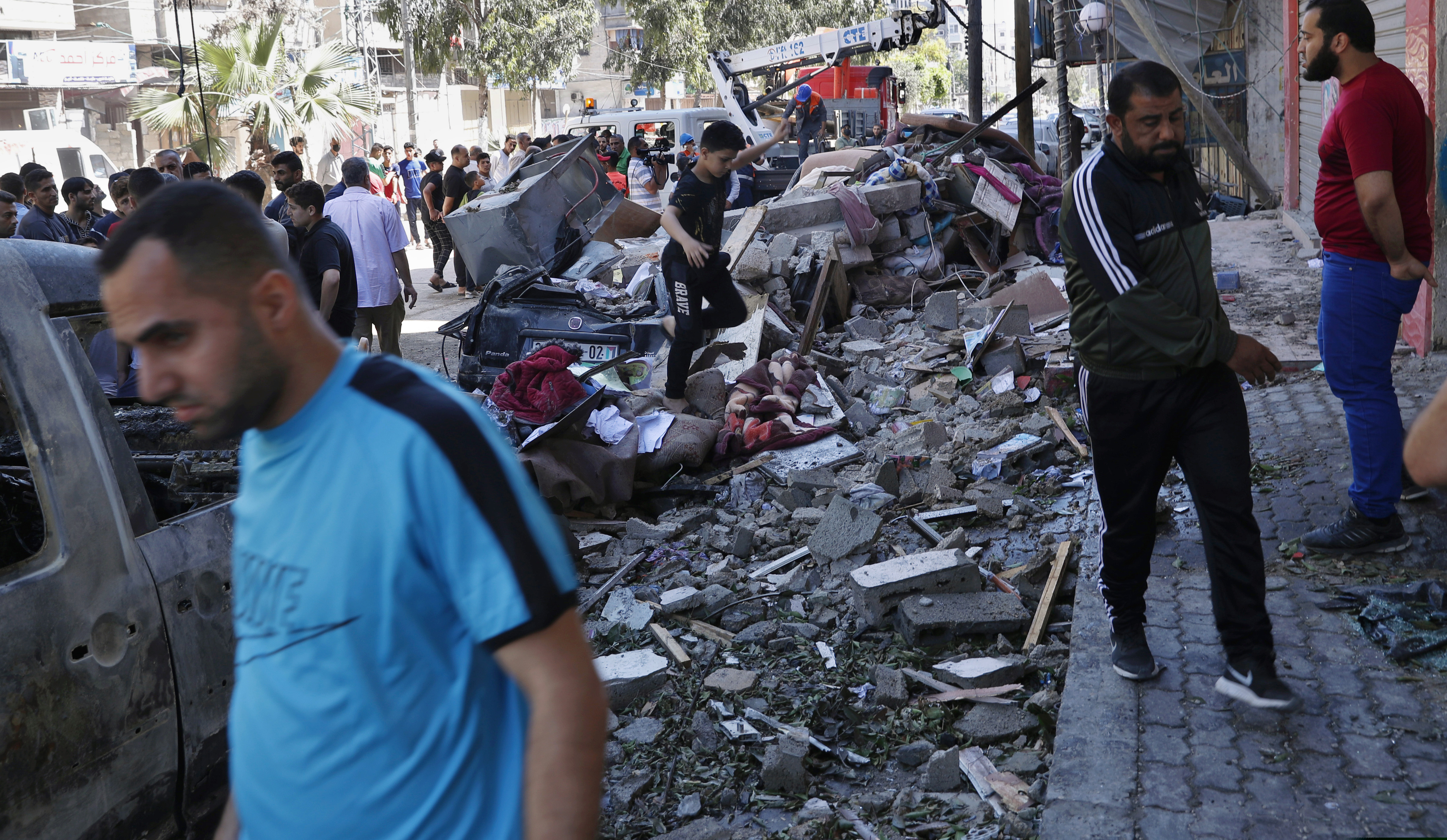 People inspect the rubble of destroyed the Abu Hussein building that was hit by an Israeli airstrike in Gaza City on Wednesday morning.