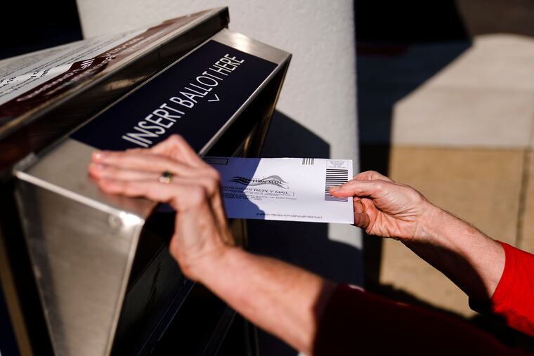 A mail-in ballot is deposited into an election return box in Willow Grove Tuesday.