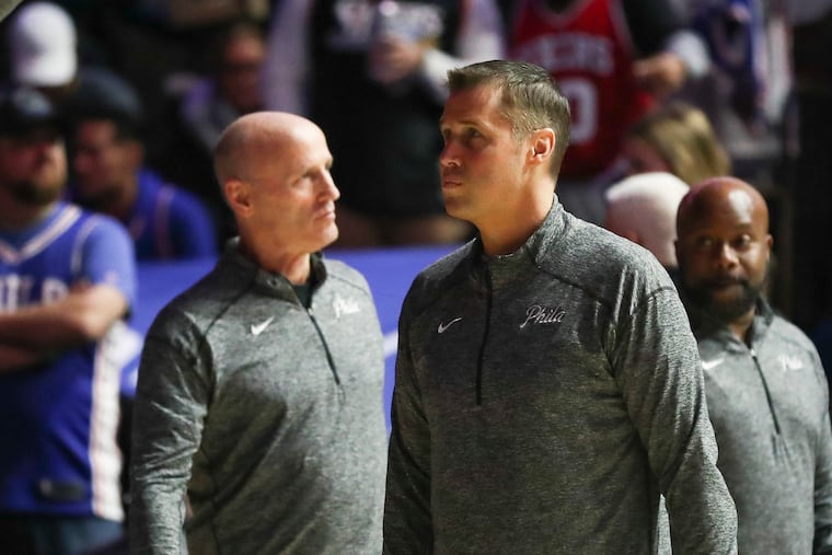 Sixers assistant coach Dave Joerger, center, stands during player introductions before a game between the Sixers and Pacers.