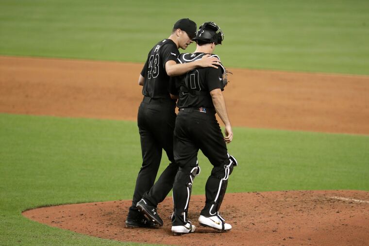 Nick Pivetta talks to catcher J.T. Realmuto during the third inning of the Phillies' 19-11 loss to Miami back on Aug. 23. Pivetta has struggled both as a starter and as a reliever this season.