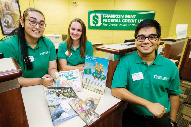 Students (from left) Mariam Sharobeem, Valerie Cheney, and Ahad Rafi worked at Franklin Mint Federal Credit Union branches set up in their high schools and said they learned a lot about personal finance.